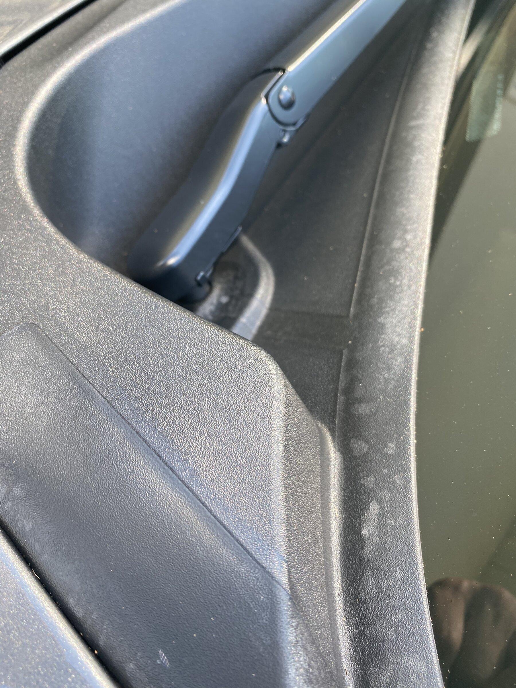 White spots appearing along the bottom of the front windshield trim ...